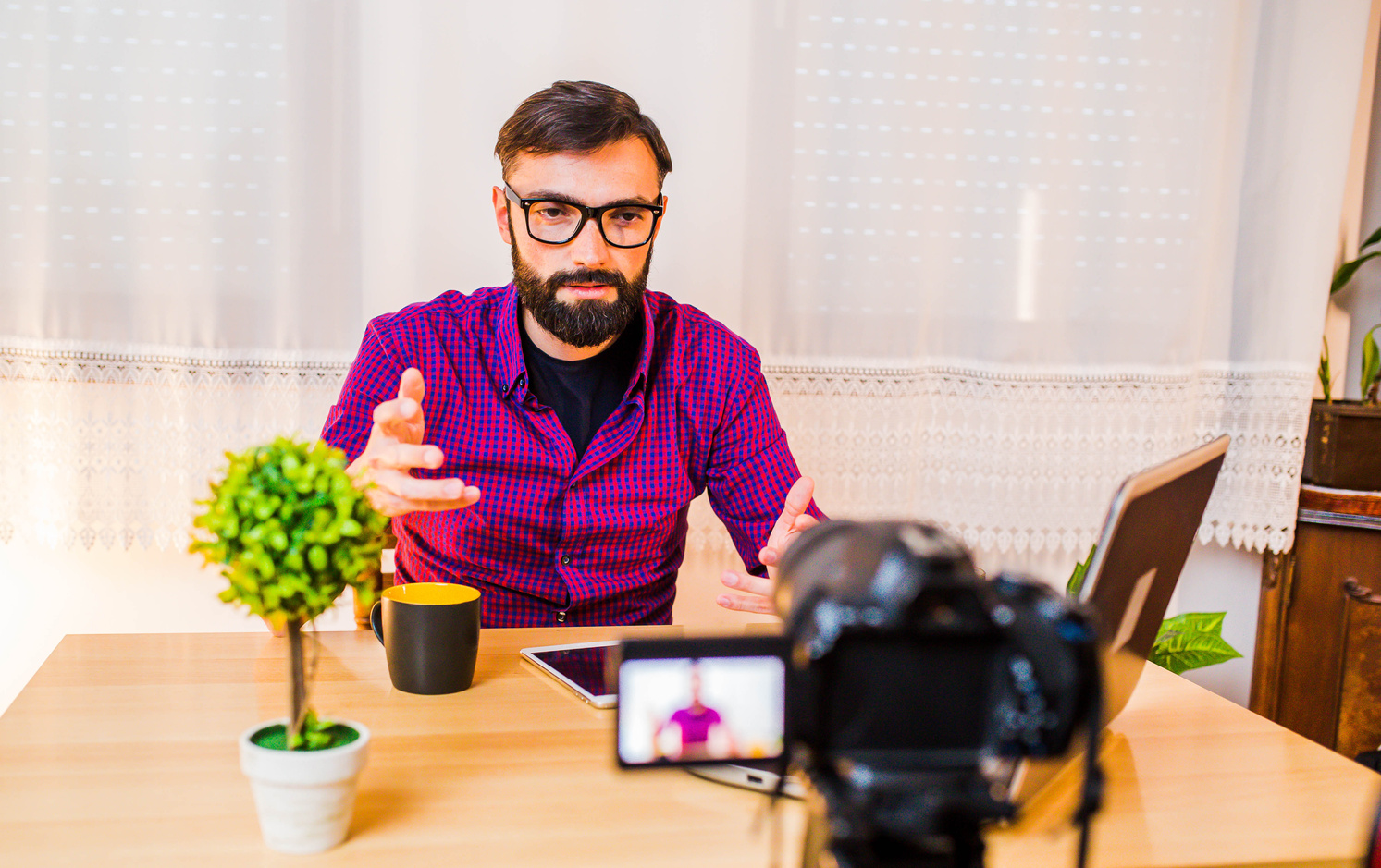 Male video blogger recording video blog.
